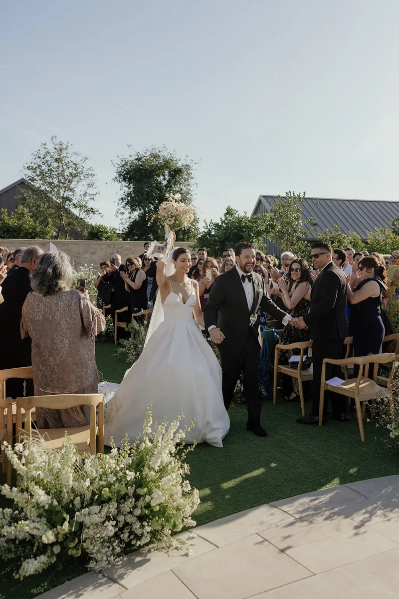 Kiana and Roland, married, back down the aisle