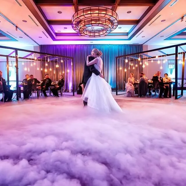 First dance on a low cloud of dry ice, the room lit purple and blue